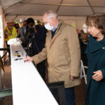 a person signs a steel beam for the student center at The College of Wooster