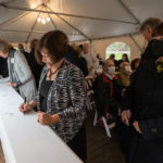 a person signs a steel beam for the student center at The College of Wooster