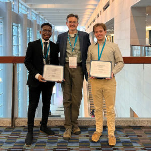 Robby Beal, Professor Mark Snider, and Joel Brown pose with awards