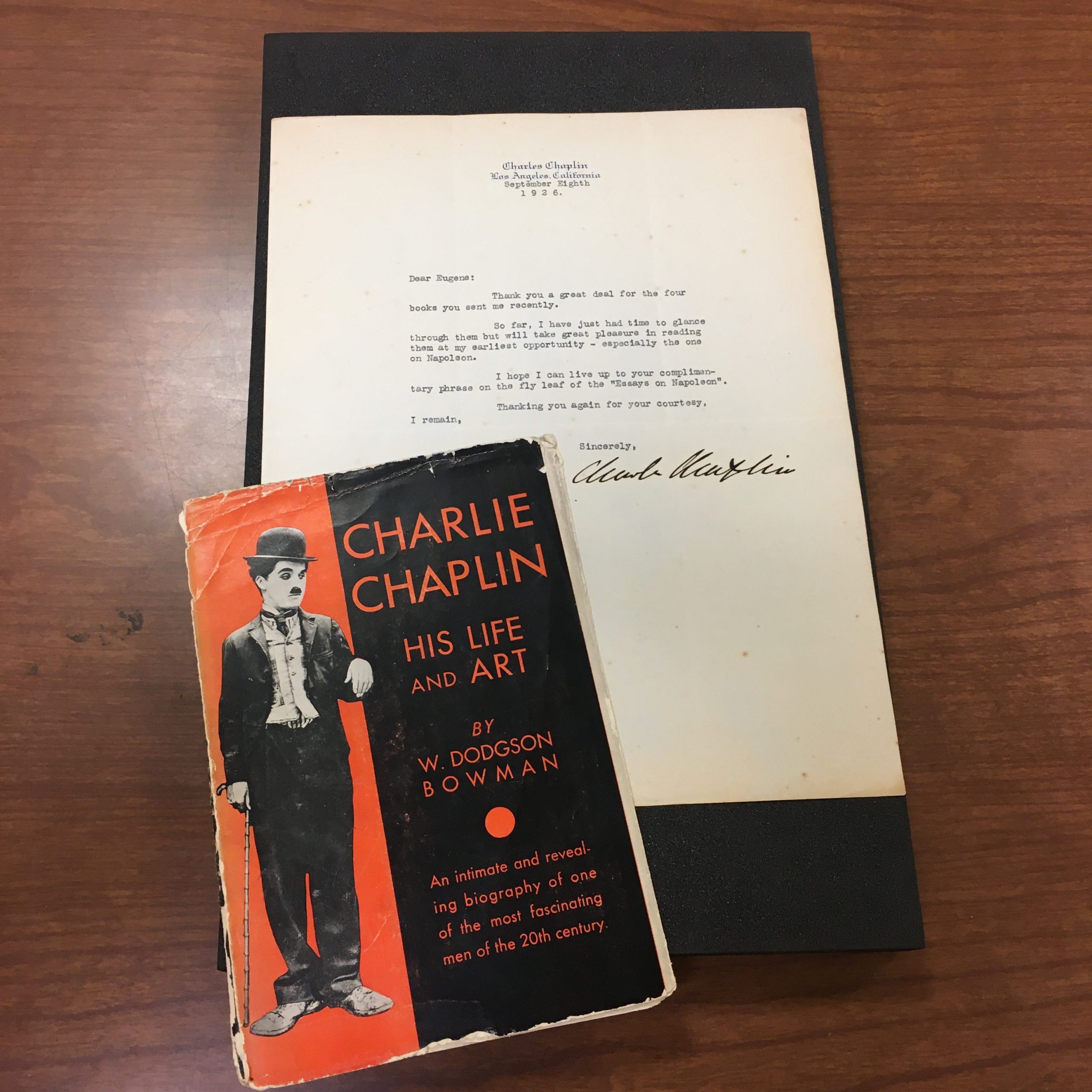 A letter addressed to Mr. Wolfe from Charlie Chaplin. With the letter is a copy of the book, "Charlie Chaplin: His Life and Art" by Dodgson Bowman.