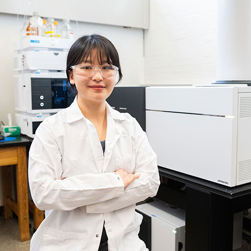 Image: Yubin Kim '24 with Wooster's advanced mass spectrometer, an instrument that allows researchers to study the makeup of rainwater samples.