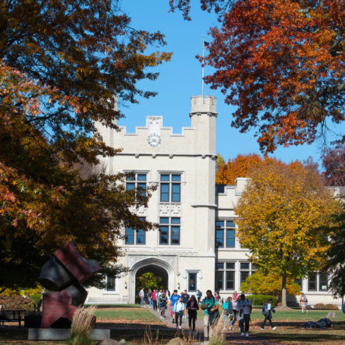 Students walk on the quad in front of Kauke Hall in the fall at The College of Wooster.