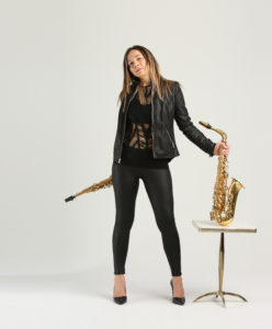 Sharel Cassity holds saxophones in a photo