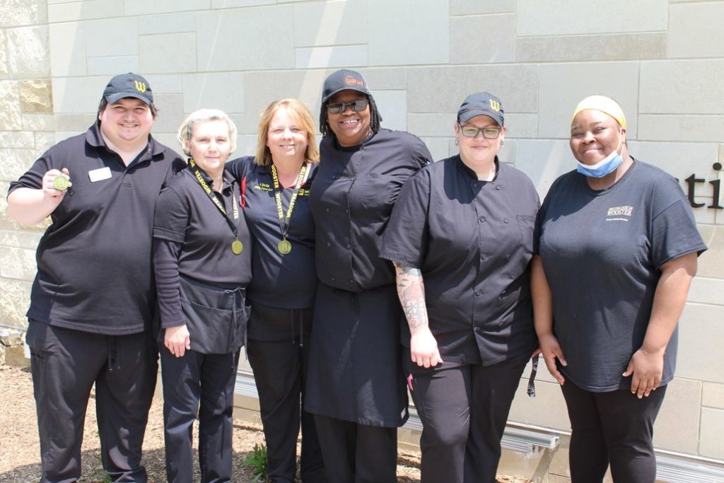 A group of Creative Dining employees at The College of Wooster displays their Arch Medals