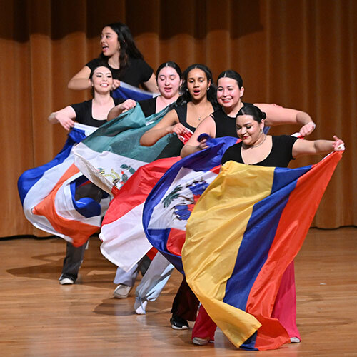 students dancing with flags