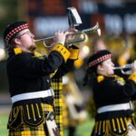 Students performing with the Scot Marching Band at a football game