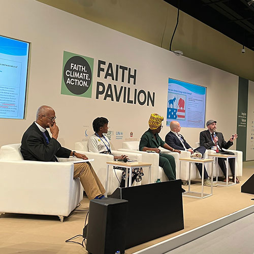 Webb presents on religious resistance to climate action in the Faith Pavilion inside the COP venue, alongside other faith leaders from around the world.
