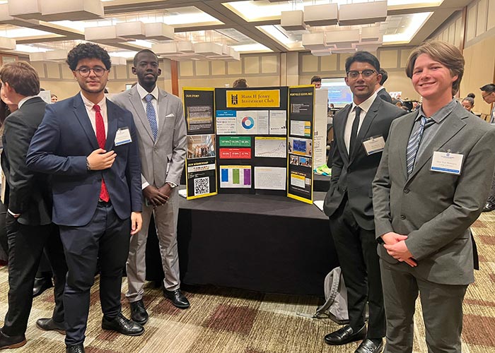 Jenny Investment Club, represented by Club President RM Shahriar Hoque ’25 Hoque (second from right), and fellow officers, Rayan Dos Passos ’25, Alan Musabeyezu, ’25, and Ben Van Horssen ’25, received fourth place and an honorable mention in an international poster presentation competition at the Student Managed Investment Fund Consortium in Chicago.
