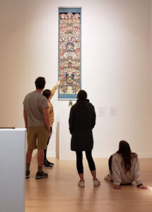 Four students examine artwork in The College of Wooster Art Museum.