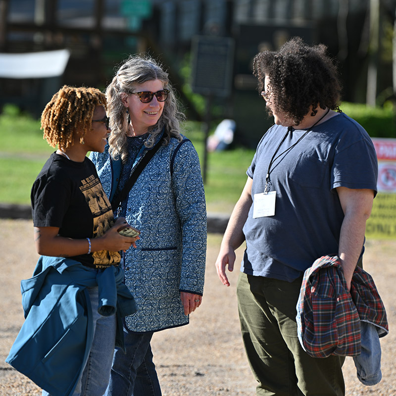 Denise Bostdorff, professor of communication studies at The College of Wooster, engages with students from her Rhetoric of Black Civil Rights course after crossing Edmund Pettus Bridge in Alabama, part of an experiential learning trip in 2023. Photo by Matt Dilyard, The College of Wooster.