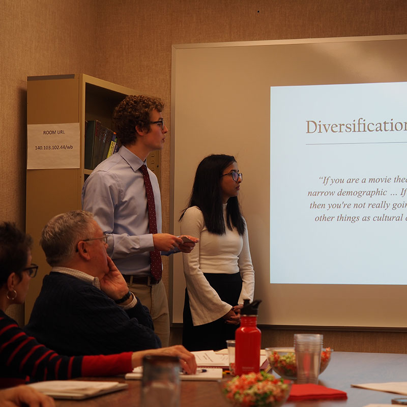 Blake Southerland ’20, business economics major, (left) and Bijeta Lamichhane ’22, communication studies and mathematics major, present membership program research and plan recommendations to the Lyric Theater’s board in 2019.
