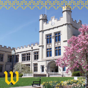 Kauke Arch at The College of Wooster, a castle-like stone building with towers and an arched entrance, framed by blooming pink trees and yellow flowers on a sunny day.